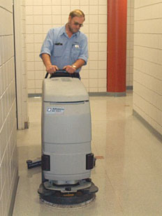 Custodian cleaning floor