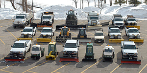 Snow plows in parking lot