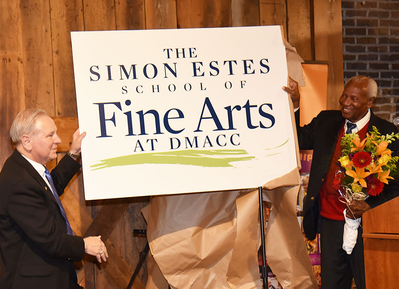 DMACC President Rob Denson and Simon Estes holding sign that says The Simon Estes School of Fine Arts ad DMACC