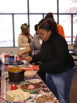 Students lining up for food at table