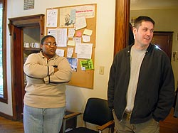 Two people standing in hallway